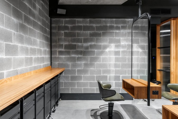 A hair salon with a brick wall and a mirror. A hair salon with a brick wall and a mirror.